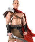 Man wearing Medieval Viking Belt And Faux Leather Arm Guards Bracers Set 3 Piece For Cosplay with sword and red cape
