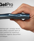 Close-up of hand holding sample of Ultra Comfy Three Quarters Inch Thick Gel And Foam Anti Fatigue Floor Mat showing gel and foam layers