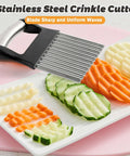Front view of stainless steel crinkle cutter with black handle for vegetables and waffle-cut fries.
