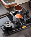 Daily Driver Barista Coffee Accessories Set Featuring Calibrated Spring Tamper Stirring Needle And Distribution Tool For Truly Smooth Espresso Pulls At Home displayed on a black tray with tools and coffee grounds.