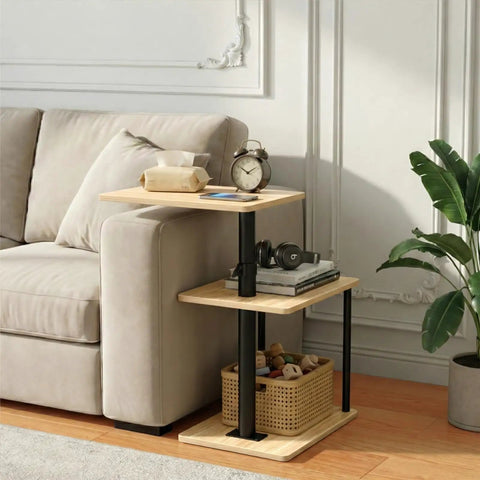 Built Tough 360 Degree Swivel C Shaped End Table With Roomy Three Tier Open Storage Rack And Heavy Duty Metal Frame Featuring Slick Oak Finish For Couch Or Bedside next to a sofa.