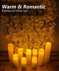 Flameless LED Candle Set Of 10 Pillar Candles Waterproof Resin For Indoor Outdoor Use Ivory With Realistic Flickering Flame And Warm Yellow Glow Battery Operated Heights 4 5 6 7 Inches arranged in front of flowers
