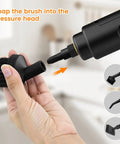 Hand holding black brush attachment for 18 Piece Top Shelf Steam Cleaner Accessory Kit, designed for versatile cleaning tasks.