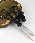 Side view of laser-guided sewing scissors with ergonomic black handle and long silver blades beside a tan tactical pouch.