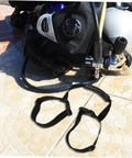 Grip Ready Scuba Tank Retainer Band And Carry Strap For Diving Cylinders next to diving gear on tiled surface
