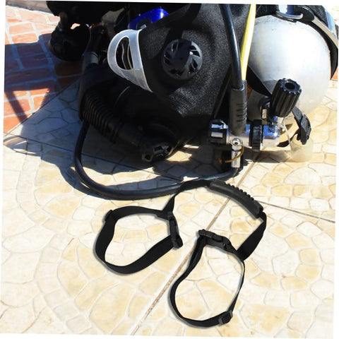 Grip Ready Scuba Tank Retainer Band And Carry Strap For Diving Cylinders next to diving gear on tiled surface