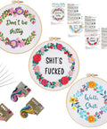 Three Sets Of Funny Embroidery Kits For Beginners With Flower Wreath Pattern And Funny Words Pattern DIY Easy Cross Stitch And Needlepoint Starter Kit For Adults Includes Clear Instructions And Colorful Threads, showing finished projects with hoops and threads.