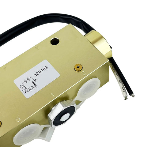 Close-up of 5-Port Directional Control Valve With 30mm Solenoid And Manual Override, brass and steel construction.
