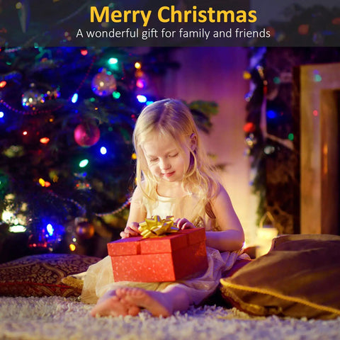 Young girl with Christmas gift in front of decorated tree