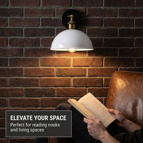 Industrial Dome Wall Sconce, White, 180° Adjustable Vintage Wall Light illuminating a reading nook on a brick wall.