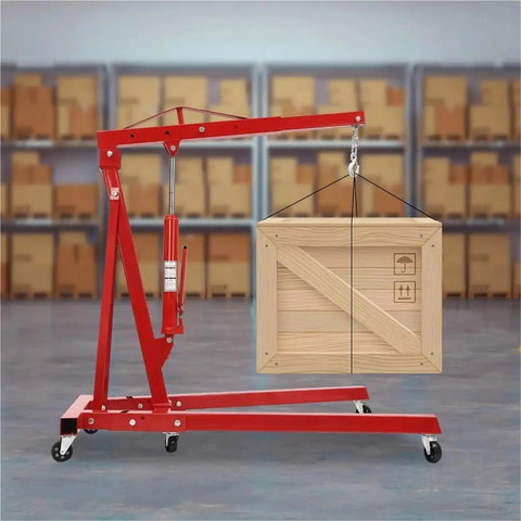 Heavy Duty Garage Workhorse: 2 Ton Hydraulic Engine Hoist With Adjustable 0.5 To 2T Range lifting a wooden crate in a workshop.