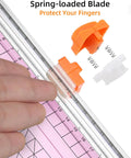 Close-up of Pink A5 Paper Cutter Guillotine With Side Ruler for Scrapbooking showing spring-loaded blade mechanism.