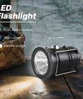 Collapsible Solar Camping Lantern With USB Rechargeable LED Flashlight on a wooden surface, handle visible, emits light
