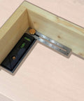 Straight Shooter Nine In One Measuring And Marking Tool featuring dual levels measuring an angle on wooden material.