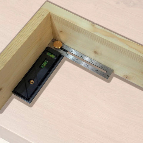 Straight Shooter Nine In One Measuring And Marking Tool featuring dual levels measuring an angle on wooden material.