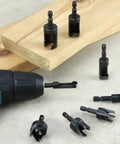Eight Piece Wood Plug Cutter Drill Bit Set With One Quarter, Five Sixteenths, Three Eighths And One Half Inch Sizes And One Quarter Inch Hex Shank For Clean, Professional Plug Fittings In Woodworking shown with wood and drill.
