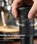 Close-up of 54mm Espresso Tamper With Adjustable 20 To 30 Lb Dial Audible Click Feedback 24 Dial Steps in use, showing dial adjustment.