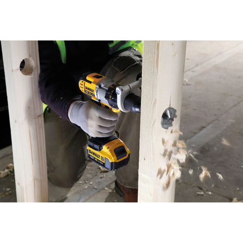 Worker using Workhorse Self Feed Spade Drill Bit For Tough Job Sites And 28 Millimeter Aggressive Cutters With Lockdown Shank on timber.