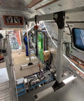 Built Damn Tough Portable Gantry Crane 1 Ton Capacity in a workshop setting with smooth wheels and heavy duty frame.