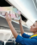 Flight attendant placing colorful Go To 20 Inch Carry On Luggage With Spinner Wheels And USB Port in overhead compartment