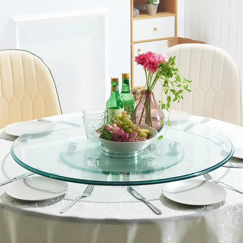 Clear Round Glass Lazy Susan Turntable For Dining Table With 360 Degree Swivel Easy Spin Smooth Quiet Rotation Serving Tray Stand 120cm 47 Inch Diameter Great For Kitchen Counter Dining Room Family Dinners And Party Tables holding dishes and flowers with dining chairs around.