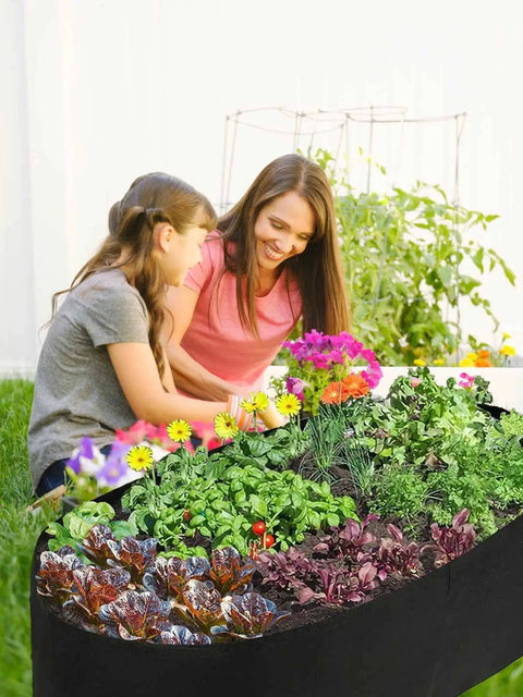 Fabric Raised Garden Bed 2Ft By 4Ft No Fuss Durable Planting Bed For Vegetables, Plants, And Flowers in use on a patio with flowers.