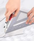Hands using Aluminum Rafter Square 7 Inch With Double Sided Engraved Scales For Precise Carpentry And Woodworking on marble surface