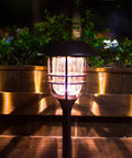 Lit Solar Path Lights 4 Pack Waterproof Metal Outdoor Lights with Glass and Stainless Steel Housings illuminating walkway by night
