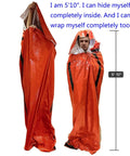 Person demonstrating Emergency Survival Sleeping Bags 2 Pack For Cold Weather Camping And Outdoor Rescue Mylar Thermal Bivy Sack size.