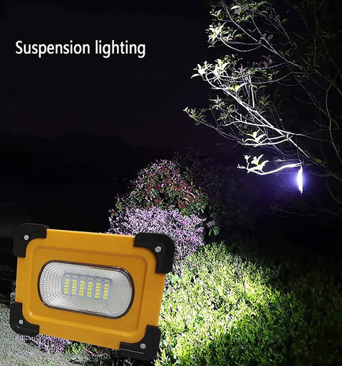 Heavy Duty 60W LED Work Light 15000 Lumens Rechargeable Waterproof Floodlamp on display with suspension lighting outdoors.