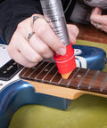 Complete Guitar Care Kit And Clean Polish Set With Fretboard Conditioner Three Premium Microfiber Cloths Zero Grease Formula applied on guitar fretboard.