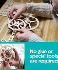 Aero Clock Wooden 3D Puzzle With Pendulum Gravity Powered Clock Kit being assembled on a wooden table, showing clock gears