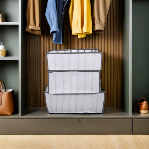 Total Closet Game Changer 3 Pack Seven Grid Foldable Bins With Grippy Handles on a shelf organizing clothes and accessories.