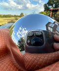 2.5 Inch Bearing Balls 63.5mm Hardened Chrome Steel AISI 52100 reflecting a house, ideal for hub bearings and machinery.