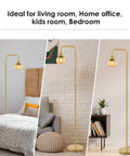Modern Floor Lamp With Amber Glass Globe Shade And 6W LED Bulb in bedroom, living room, home office setting, brass gold finish