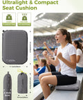 Go-To Self-Inflating Seat Cushion For Travel And Outdoors on stadium bleacher, grey, 15x11x2 in, user seated comfortably