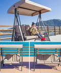 Woman sitting on a swing with a Waterproof Outdoor Swing Canopy Replacement For 2 To 3 Seater Universal Patio Cover Khaki 79x49 Inches