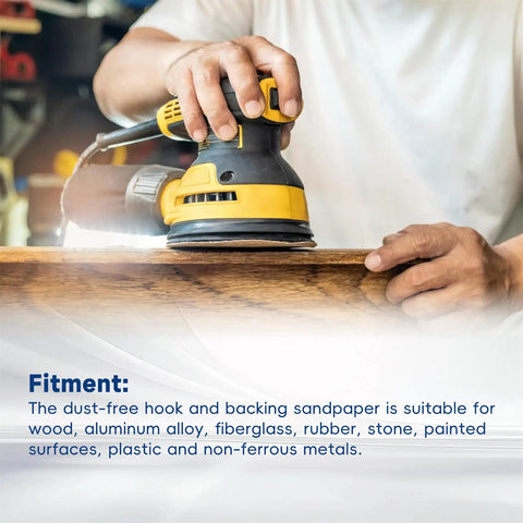 Hand using a yellow and black sander on wood, showcasing 100 Packs Hook And Loop Sanding Discs With Premium Aluminum Oxide Grit.