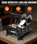 Hand Crank Bottle Labeling Machine Adjustable For Glass Metal Round Zp-50W on a table with labels in use.