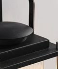 Close-up of Dope Weatherproof Outdoor Wall Light with Striped Glass, black and nickel finish, showing top and screws detail.