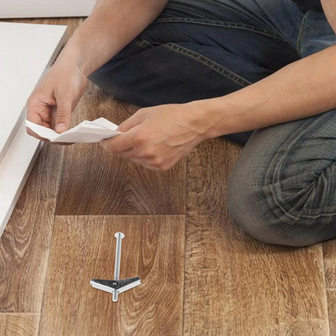 Person assembling with Heavy Duty Drywall Anchors And Toggle Bolts Kit 24 Pcs Galvanized Iron Fasteners on wooden floor