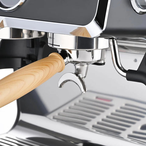 Close-up of 58mm portafilter with wooden handle on Fully Automatic Espresso Machine With Badass Burr Grinder And Hella Smooth Pulls.