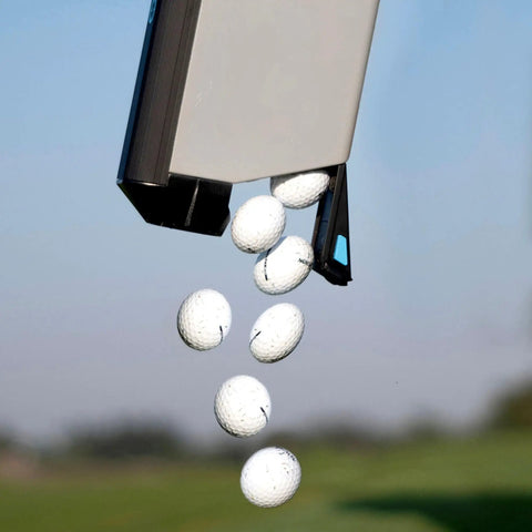 Close-up of golf balls being released from a Golf Ball Shag Portable Ball Picker, Compact Practice Essential, outdoors.