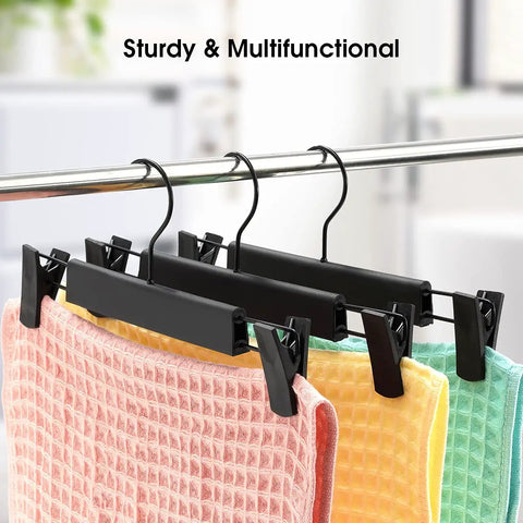 10 Pack Clothes And Pants Hangers With 360 Degree Swivel Hooks, Adjustable Clips, Space-Saving Design For Jeans, Coats, Skirts And Garments, Black Finish That Keeps Closets Neat, Easy Access And Fewer Wrinkles displayed with colorful fabric