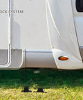 Tough Black Nylon RV Door Catch Retainer Hook Replacement For Your Motorhome Or Camper That Slams Shut With A Loud Thud And Keeps The Entry Secure While You Hit The Road displayed next to a motorhome.