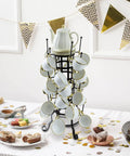 24-Hook Rustic Black Iron Coffee Mug Holder Mug Rack Cup Display Tree with white mugs on decorated table.
