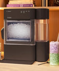 Countertop Nugget Ice Maker With 38 Lbs Daily Capacity And One Gallon Tank for chewable pebble ice beside a colorful drink.