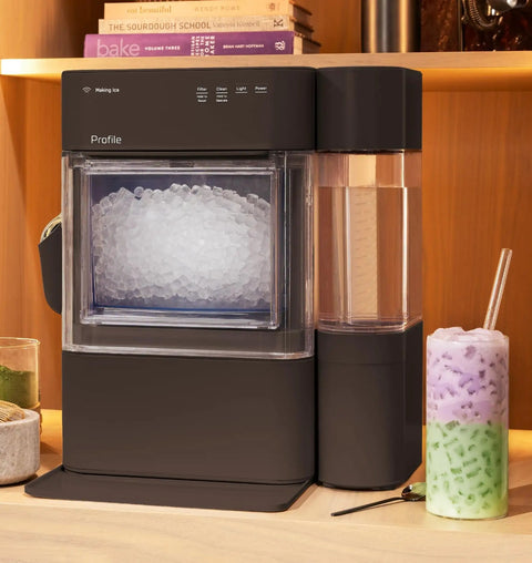 Countertop Nugget Ice Maker With 38 Lbs Daily Capacity And One Gallon Tank for chewable pebble ice beside a colorful drink.
