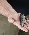 Person holding Wedge XT 500 Lumen EDC Flashlight With 1900 Candela Beam, Slim Ergonomic Design, black with pocket lanyard