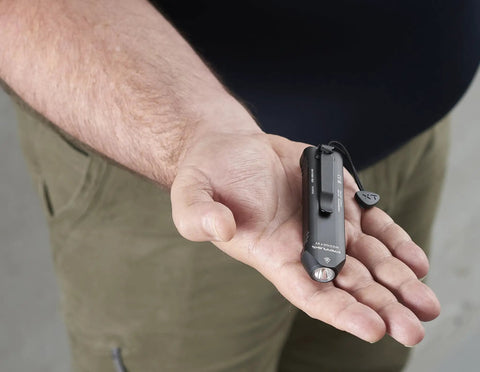 Person holding Wedge XT 500 Lumen EDC Flashlight With 1900 Candela Beam, Slim Ergonomic Design, black with pocket lanyard